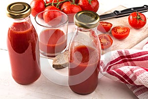 Home made tomato juice in a glass and bottle