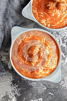 Tomato soup with noodles and meatballs