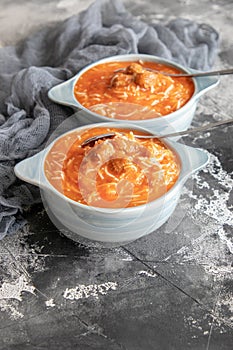 Tomato soup with noodles and meatballs