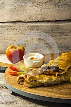 Home made very tasty apple cake, tasty apple cake with fresh apple on wooden background.