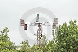 Home made wind generator from barrels in courtyard of house. An eco-friendly home source for the village from barrels