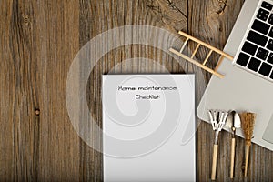 Home maintenance checklist. Gardening tools close to the laptop