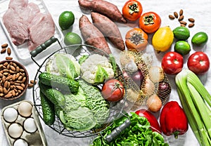 Home menu planning concept - fresh fruits, vegetables, eggs, nuts, meat on a light background, top view. Healthy diet food