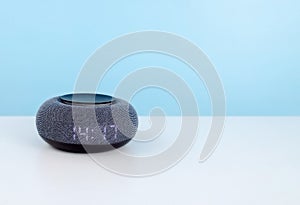 Home mini smart speaker close up. Smart AI speaker concept. Voice controlled speaker with activated voice recognition