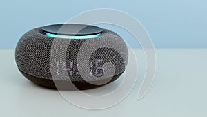 Home mini smart speaker close up. Smart AI speaker concept. Voice controlled speaker with activated voice recognition
