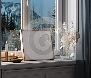Home mockup, frame close up standing on windowsill at winter evening time