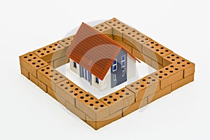 Home model with brick protective wall - house construction and safety concept