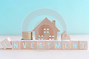 Home model and goal coins represent as money in pastel color room background. Investment wealthy freedom life