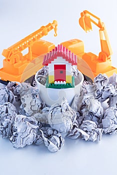 Home model in trash basket Housing investment risk concept