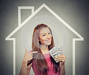 Home, money, people concept. Successful business woman holding dollar cash money