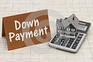 Home Mortgage Down Payment, A gray house, brown card and calculator on stone background