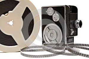 Home movie camera and film reel isolated on white