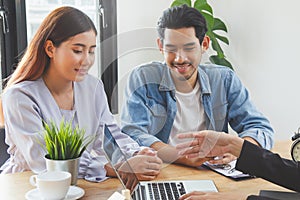 Home moving and relocation concept. Happy asian couple talking with apartment landlord from real estate agent /