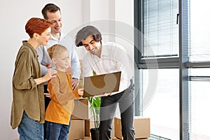 home moving and relocation concept. Happy family talking with apartment landlord from real estate agent via laptop