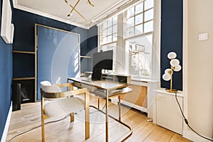 a home office with blue walls and a computer desk