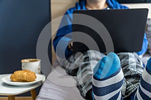 Home office concept - man working from his bed with breakfast