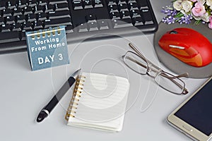 Home office desk with desktop, accessories and text written on blue note. Blurry background