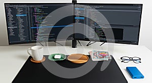 Home office desk setup with dual monitors and coding environment