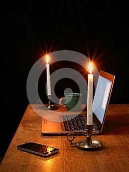 Home Office with Laptop Illuminated by Candlelight