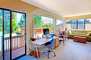 Home office and living room house interior with balcony view.