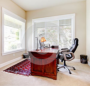 Home office with mahogany desk and letaher chair.