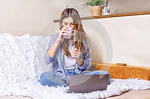 Home office woman and distance learning online education. Happy lady girl with wavy hair working at notebook sit down on