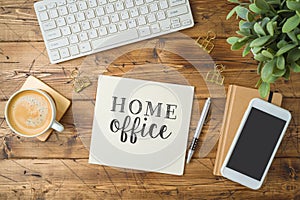 Home office and working from home concept. Table workplace with keyboard computer, notepad and coffee cup. Top view from above