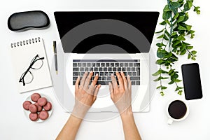 Home office workspace mockup. Laptop with blank screen, hands and accessories on white