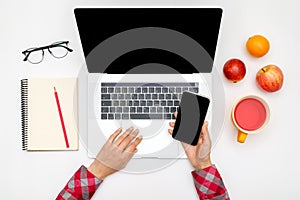 Home office workspace mockup. Laptop with blank screen, hands and accessories on white