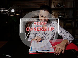 HOME OWNERSHIP inscription on the screen. Bookkeeping clerk inspecting market data