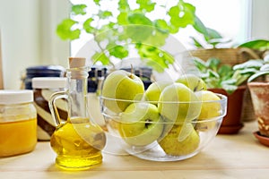 Home pantry, plants in pots, honey, chocolate paste, apples, bottle of olive oil