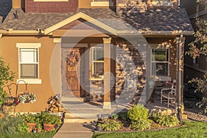 Home with pathway leading to gabled entrance of the front porch with brown door