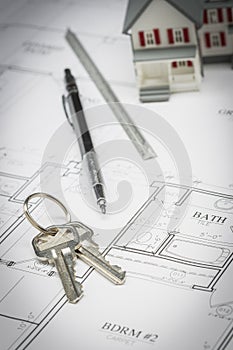 Home, Pencil, Ruler and Keys Resting On House Plans