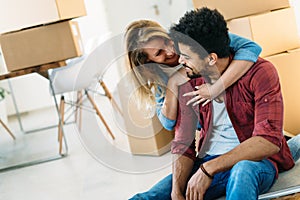 Home, people, moving and real estate concept - happy couple having fun while moving in