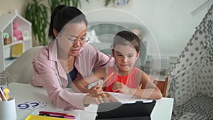 Home people remote: mom helping daughter do homework during online learning in home spbd.