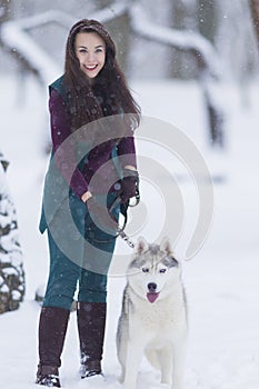 Home Pets Concept and Ideas. Happy Caucasian Brunette Woman and Her Husky Dog