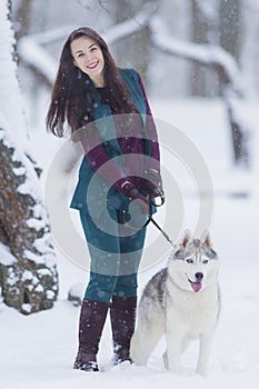 Home Pets Concept and Ideas. Happy Caucasian Brunette Woman and Her Husky Dog.