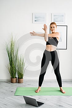 home pilates online yoga woman fitness with laptop