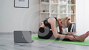 home pilates online yoga woman fitness with laptop