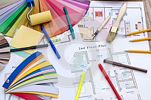 home plan, color and wooden samples, brush and work tools