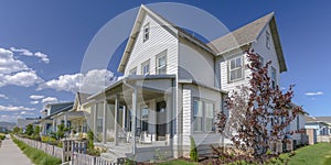 Home with porch and picket fence in Daybreak Utah