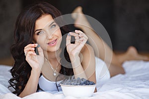 Home portrait of a happy woman with ripe berries