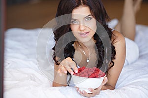 Home portrait of a happy woman with ripe berries