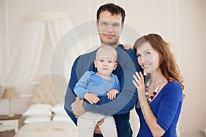 Home portrait of happy young family.