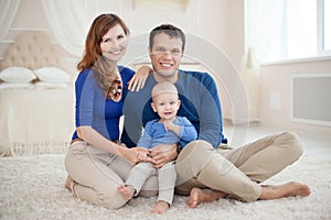 Home portrait of happy young family.