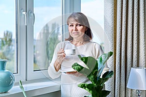 Home portrait of mature woman looking at the camera