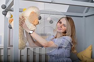 Home portrait of pregnant Happy Woman. Mom Expecting Baby. Girl on the children bed