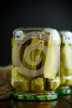 Home preservation. Canned in a glass jar ripe cucumber .
