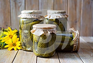 Home preservation for winter: pickled cucumbers with garlic in glass jars. Close-up