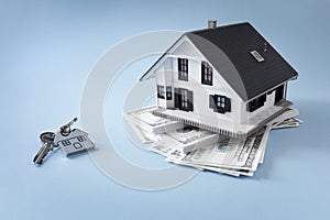 Home real estate with house key and mortgage or savings background